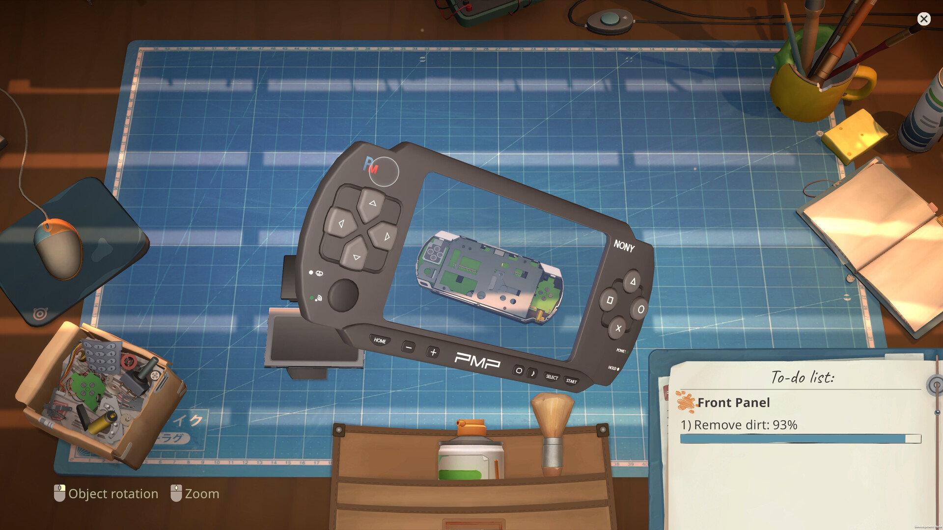 A handheld game device being repaired on a workbench in ReStory: Chill Electronics Repairs